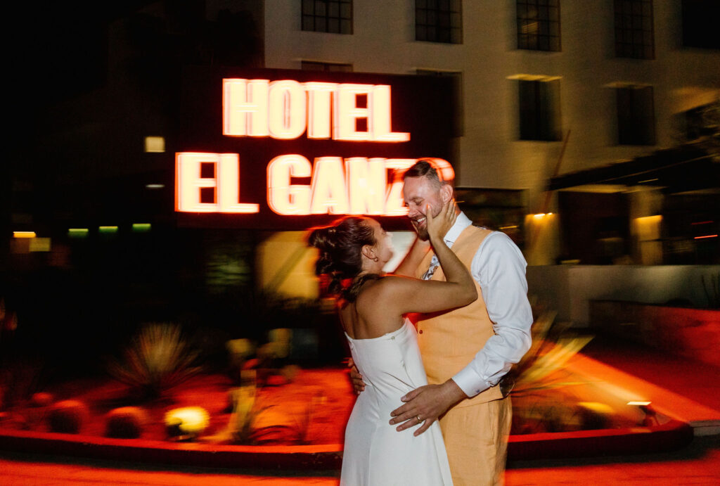 hotel el ganzo neon sign late night bride and groom portrait destination mexico wedding blurry style photo