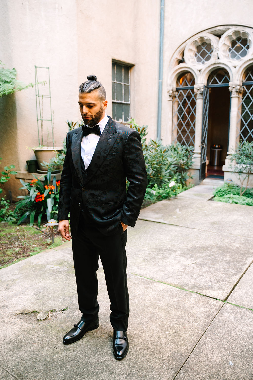 groom portraits groom wedding style man braids classy satin black suit with floral details and sparkly sequenced bowtie berkeley city club courtyard wedding first look