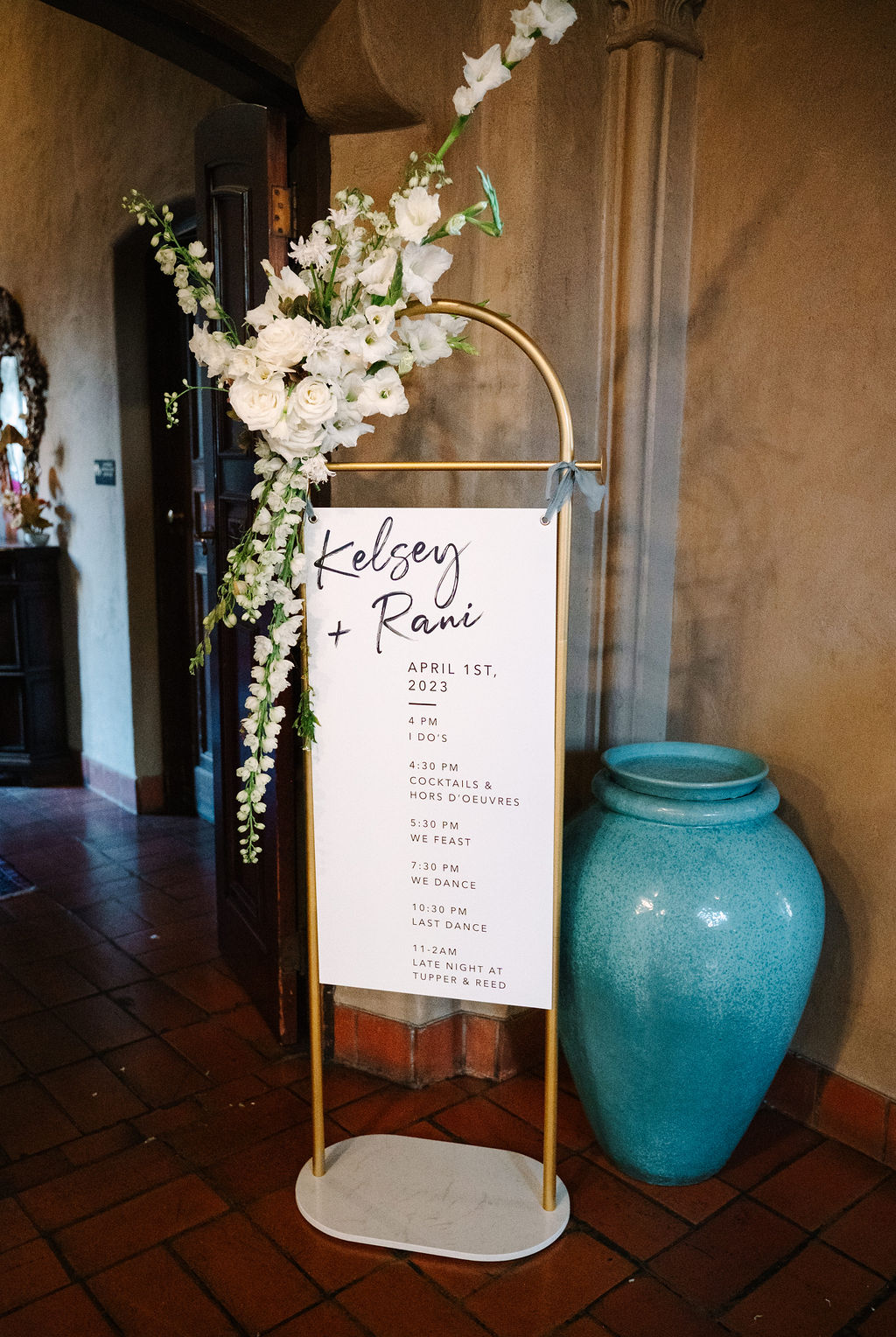 airy white delicate florals gold wedding signage frame arbor gray blue ribbon accents marble stand clean white wedding welcome sign and itinerary berkeley city club wedding
