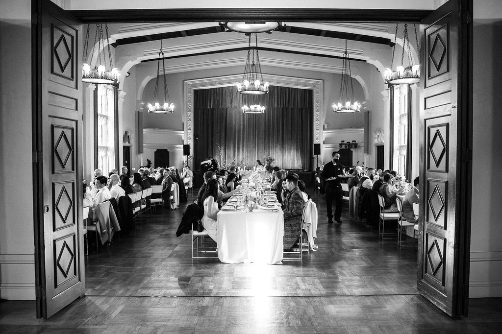 black and white wedding portrait reception in vintage theater room vintage doors