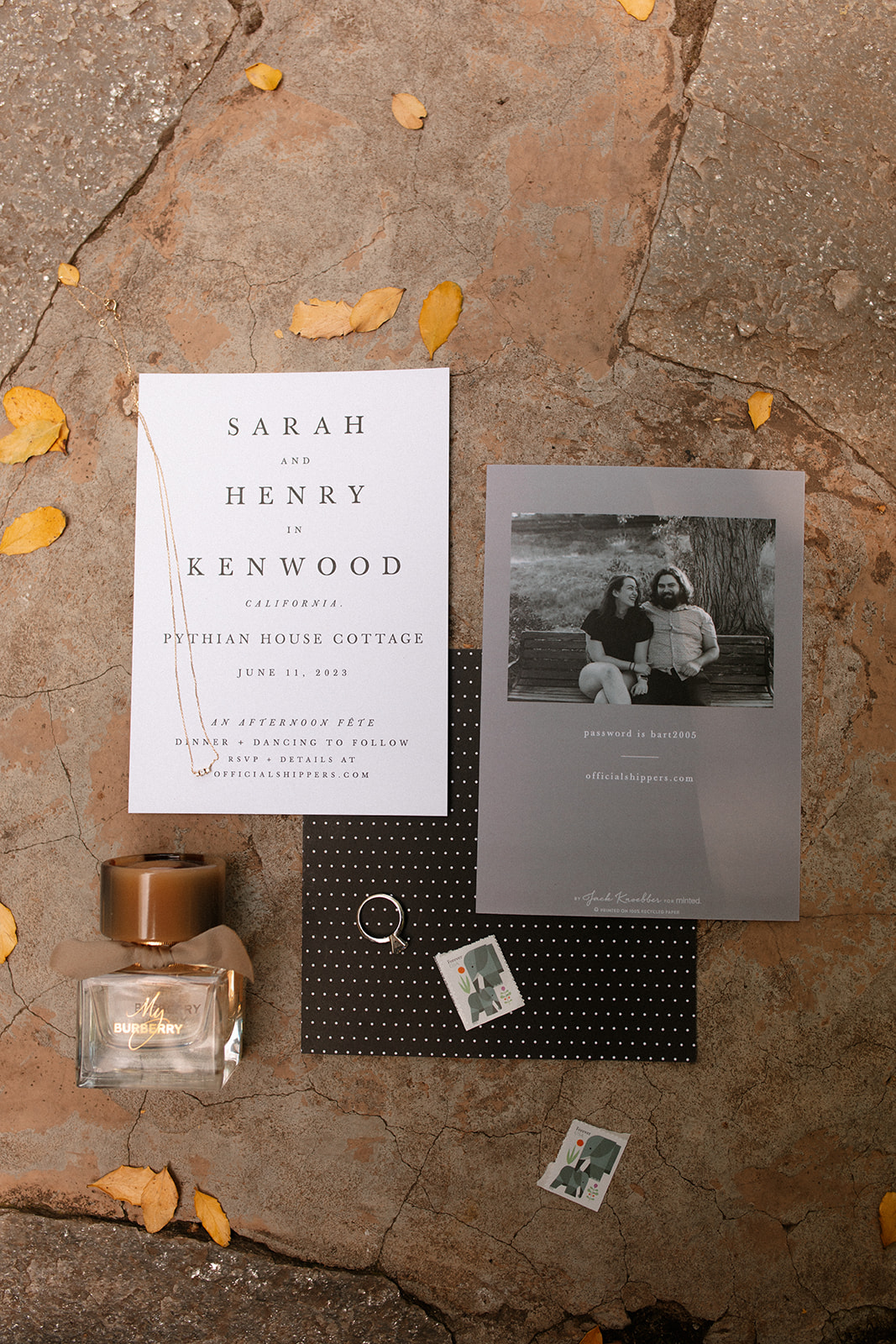 flat lay invitations clean sleek simple garden fall wedding vibes black and white wedding invitation Burberry cologne wedding ring
