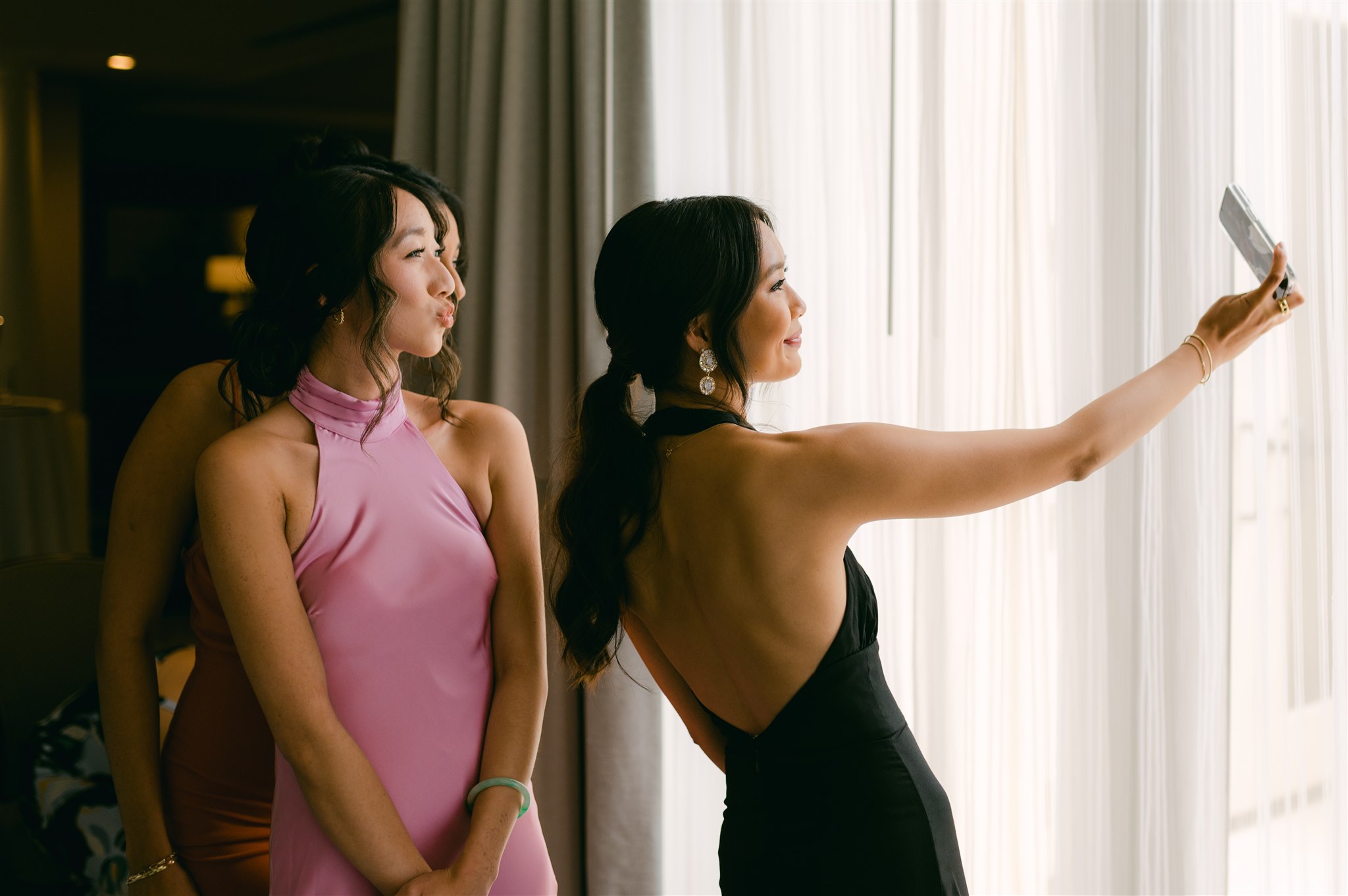 wedding guest selfie backless black dress and satin pink halter top dress open window