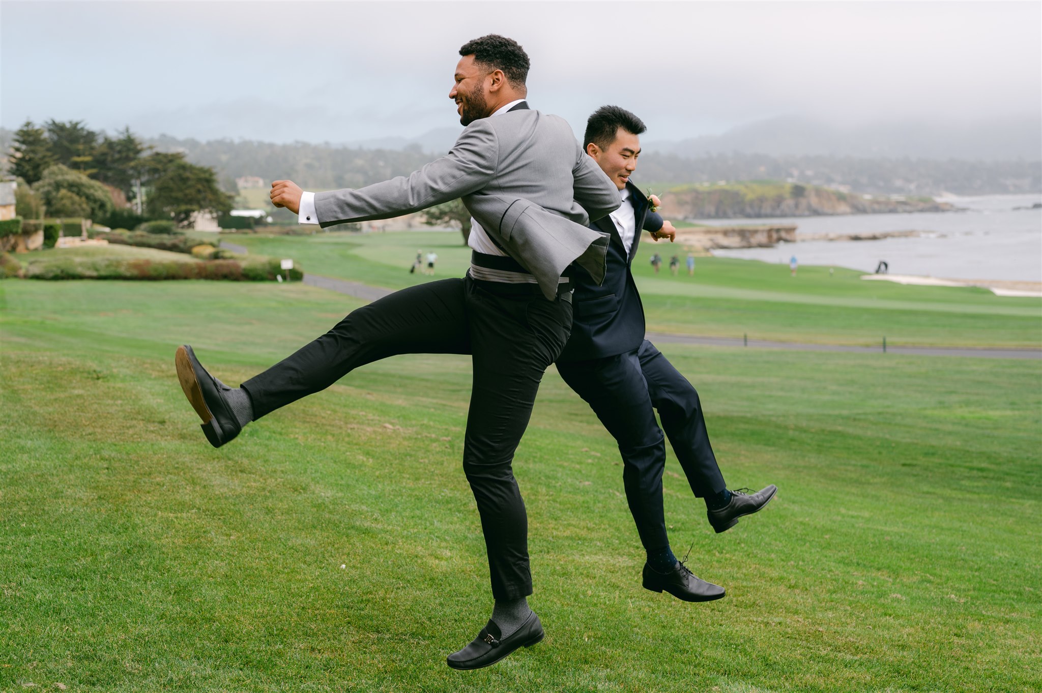 groom and groomsman jumping photo team groom beachside wedding carmel california