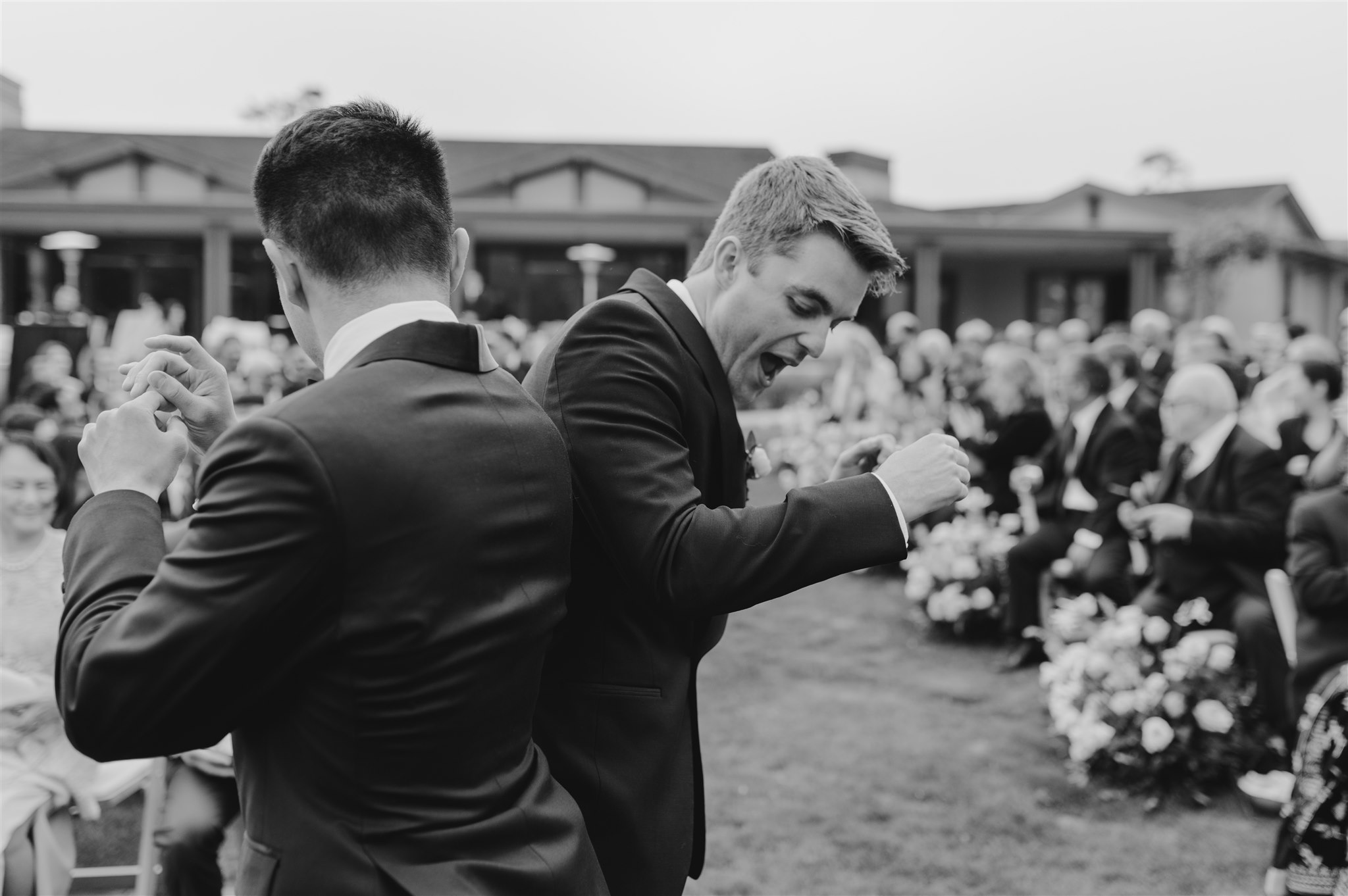 groom and groomsman greeting at the alter wedding ceremony black and white wedding portrait best friends 