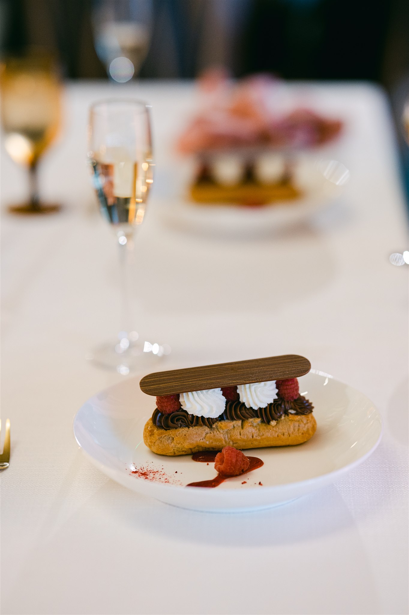 wedding dessert chocolate eclair with chocolate ganache fresh cream and raspberries and chocolate 
